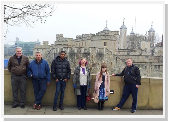 Hostel residents stand in front of the Tower of London