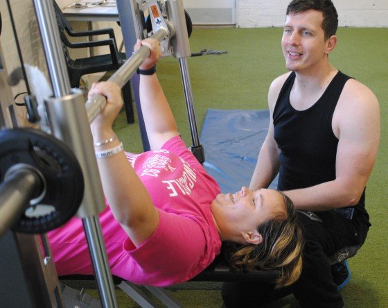 Swale Your Way member Sharon practises weights with trainer Andrew