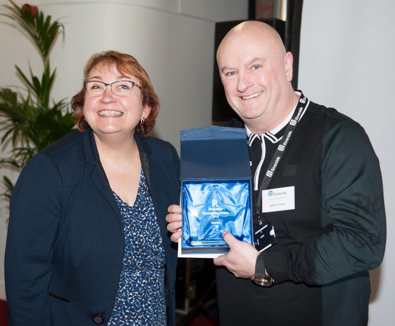 Volunteering award-winner Simon O'Brien smiles with Riverside's Chief Executive Carol Matthews