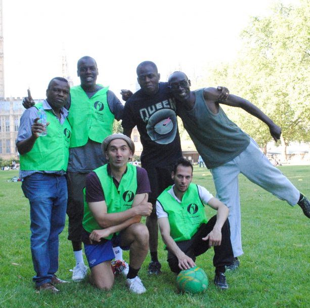 Keen footballers and hostel residents pose in their pitch by the Houses of Parliament