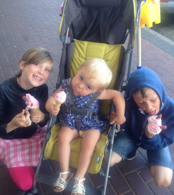 Three children have a great time eating ice cream in Cleethorpes as a break from their hostel
