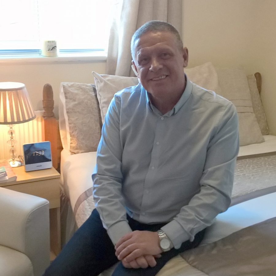 Clive in his new bedroom after resettlement