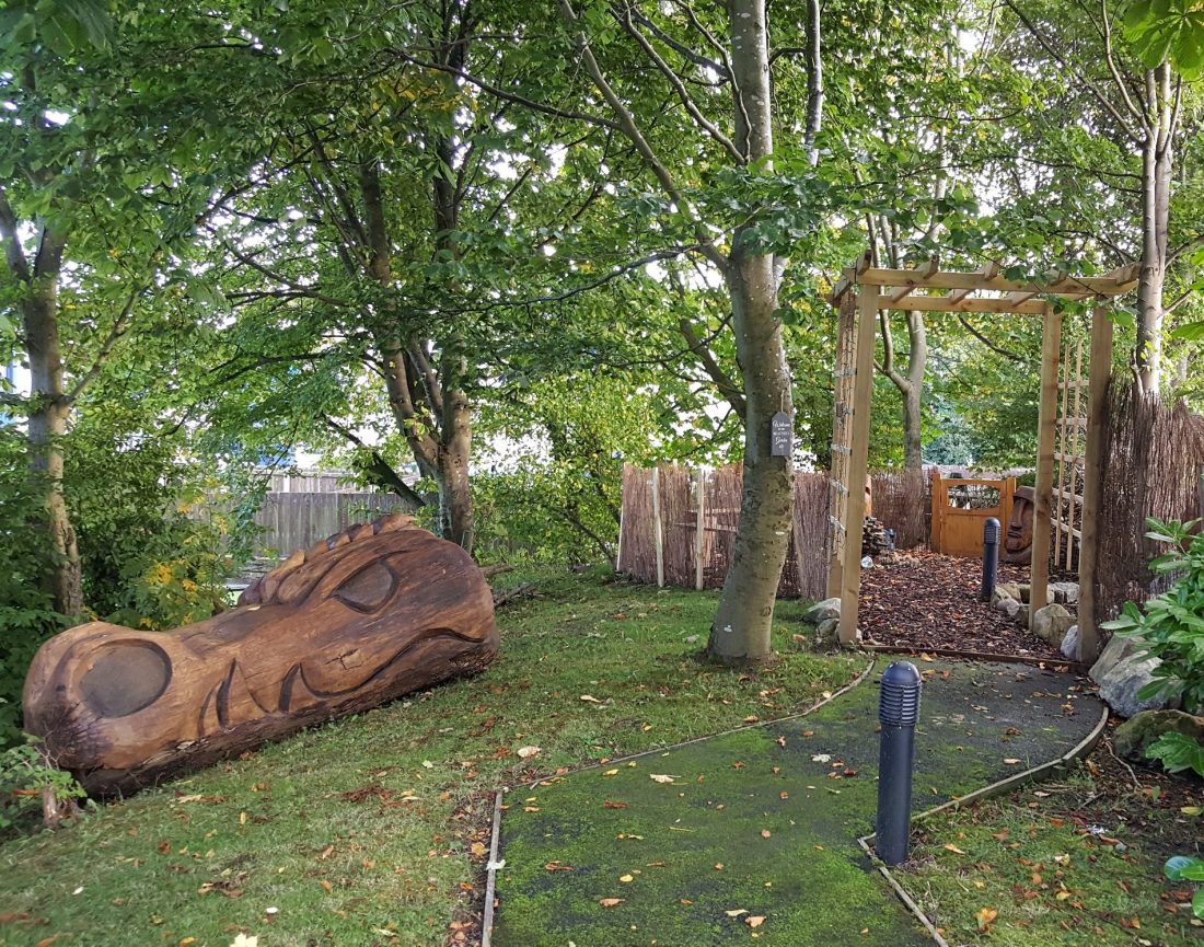 Homeless veterans' memorial garden at The Beacon with carved wooden bench and trellis