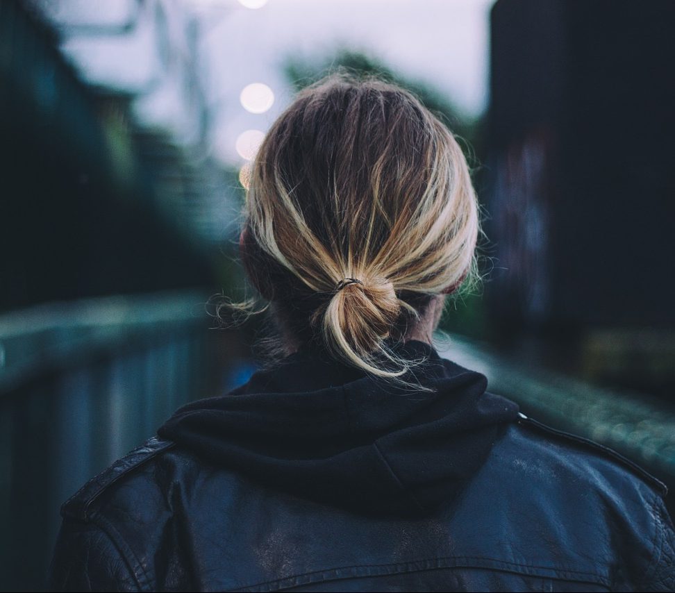 Back of woman's head as she walks down the street