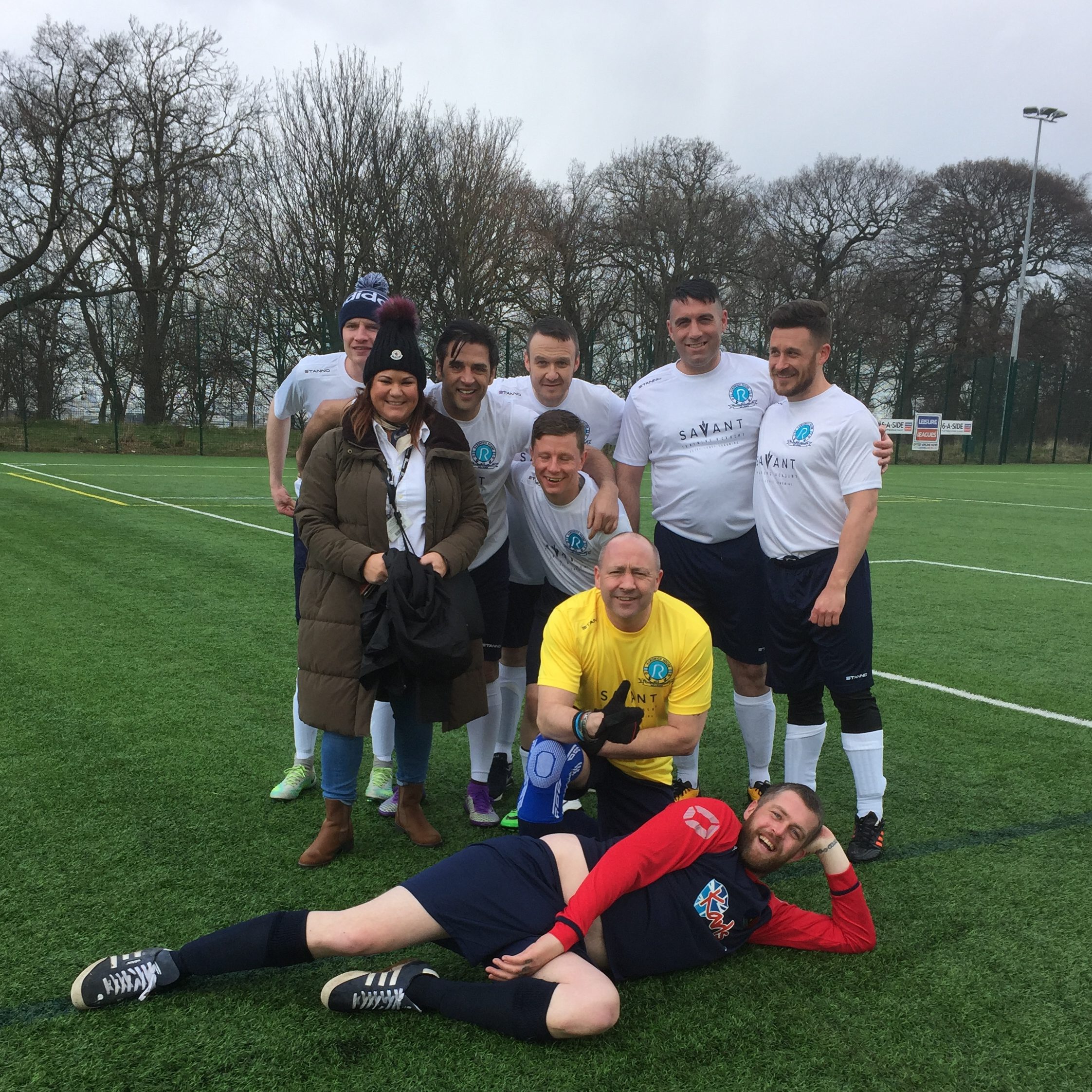 A team of veterans pose after their football match