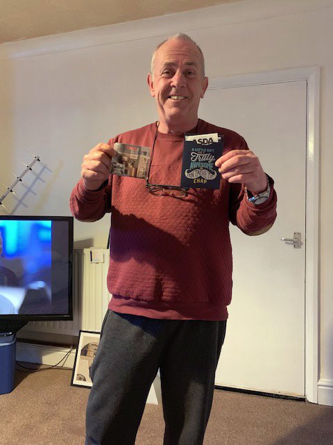 Man smiling in his flat