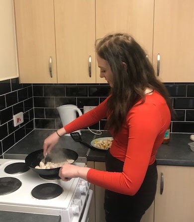 Young woman cooking in kitchen
