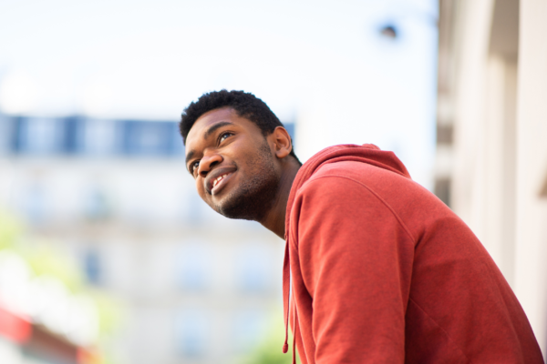 Photograph of a man in a red hoodie