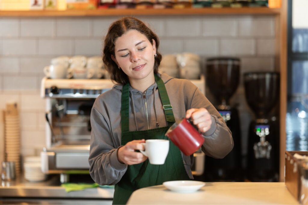 benefits trap blog young woman working coffee shop